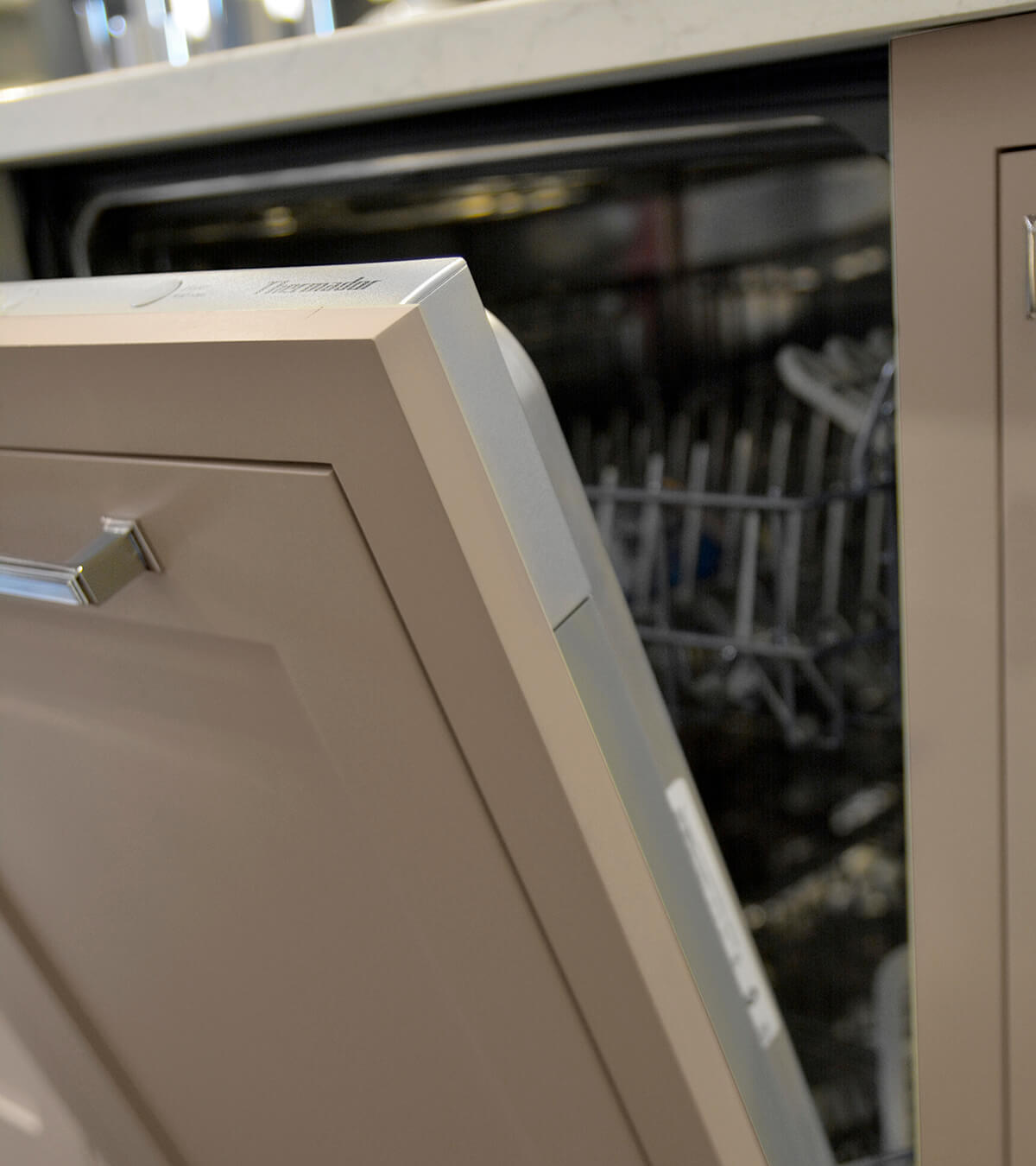 A paneled dishwasher with an inset styled cabinet panel shown when open.