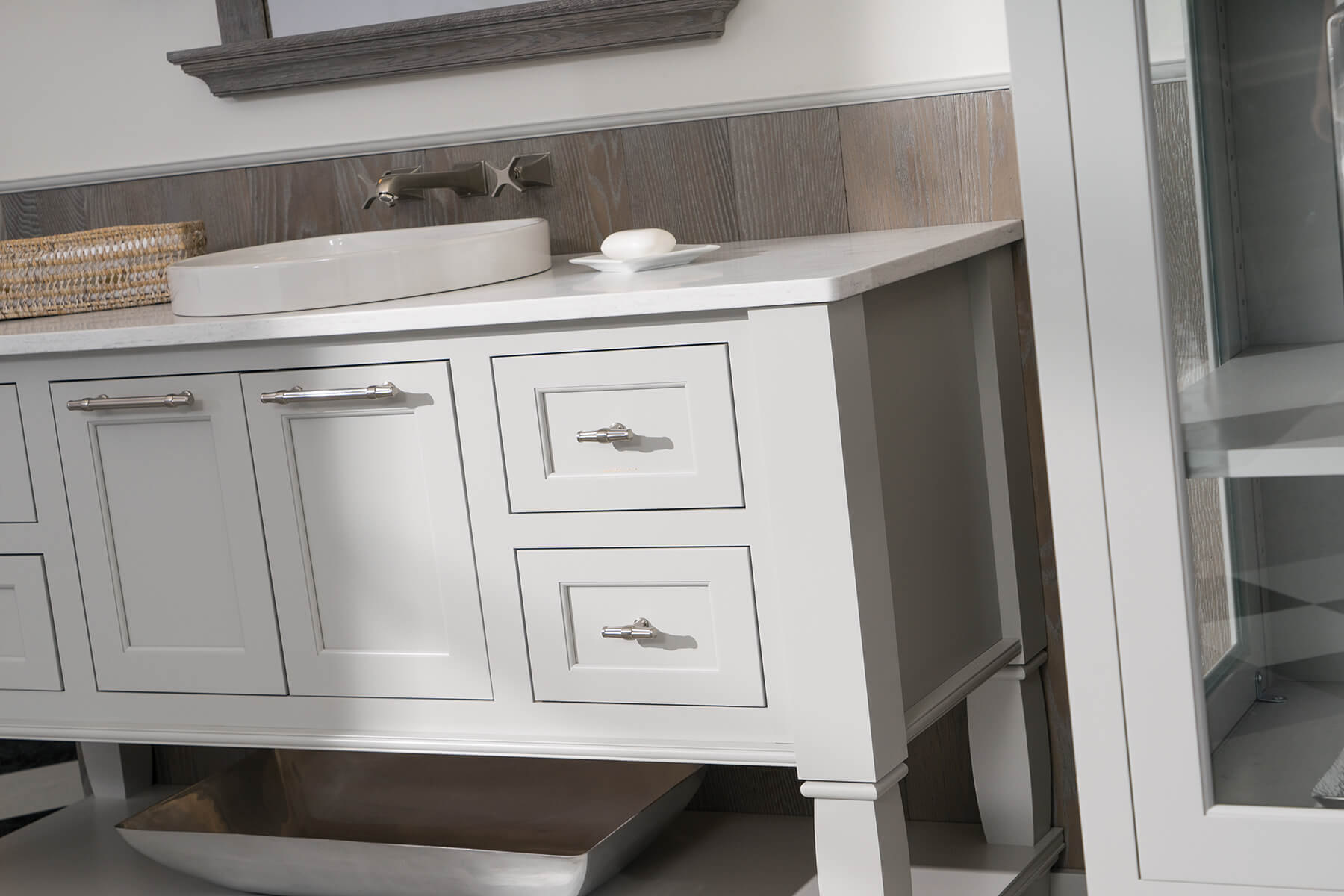 Light gray painted bathroom vanity cabinets from Dura Supreme Cabinetry.