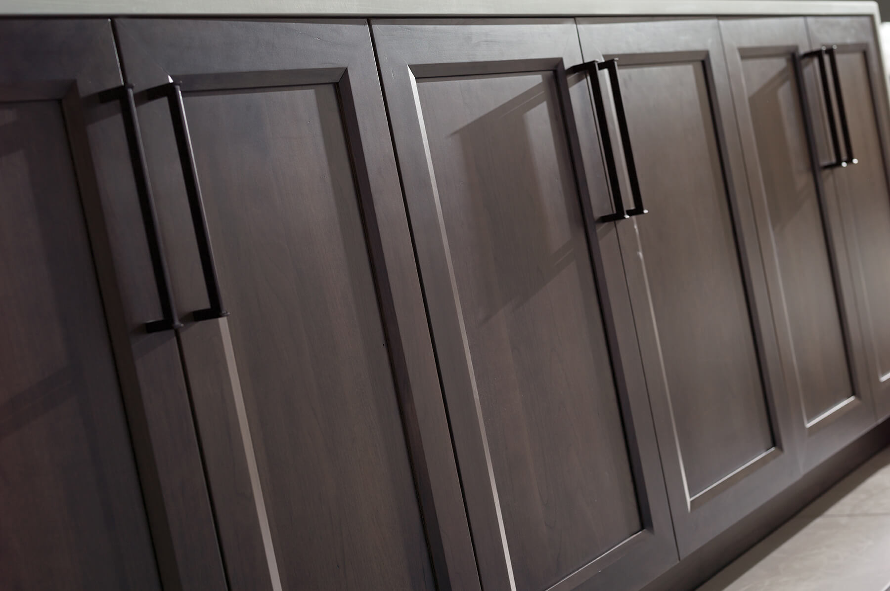 Dark gray stained kitchen cabinets from Dura Supreme Cabinetry.
