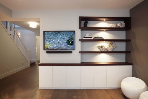 A contemporary entertainment center with built-in media cabinets.