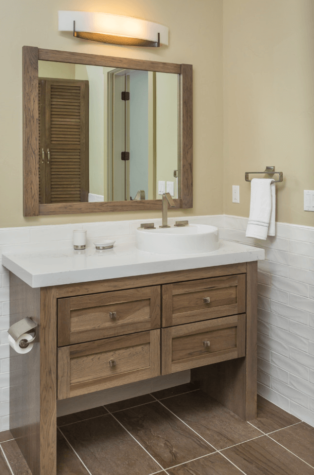 A bathroom featuring one of Dura Supreme Cabinetry's wood furniture vanities designed by Hollie M. Ruocco, CMKBD, Owner of Creative Kitchen Designs, Inc. This photo shows an example of a wood furniture vanity from Dura Supreme Cabinetry.