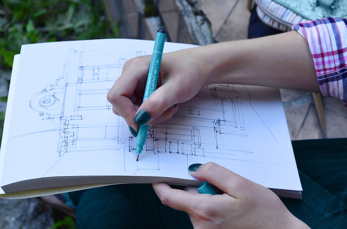 A close up of a kitchen designer drawing the cabinet design and kitchen remodel plans.