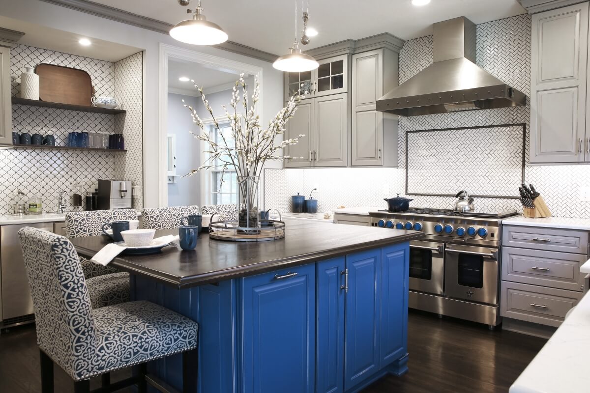 The unique blue color of the kitchen island was selected with the inspiration of the family's treasured dishware from the Czech Republic.