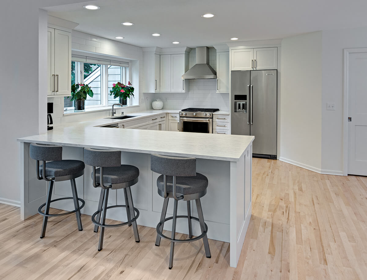 A stunning example of a U-Shaped kitchen design utilizing an open concept floor plan by incorporating a pennisula into one of the legs of the 