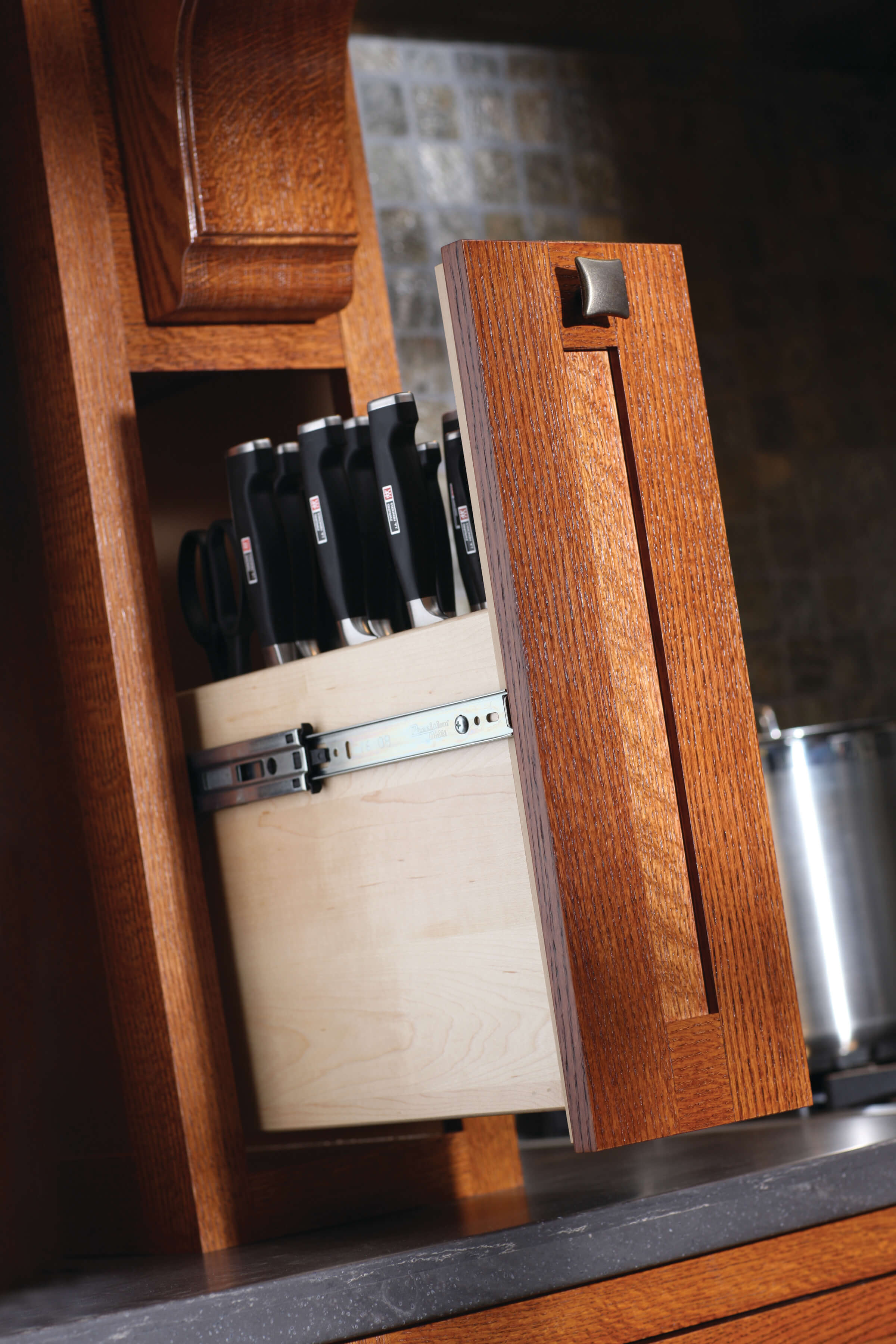 Interiors of cabinets commonly feature customized, well-thoughtout storage solutions like this wood hood pull-out for cuterly.