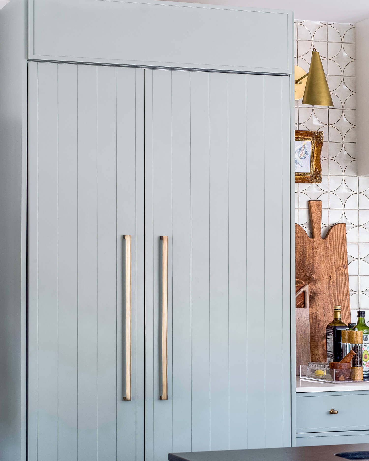 A panel-ready fridge featuring two different door styles. One with a shiplap slab detail and the other with a micro, skinny shaker style.