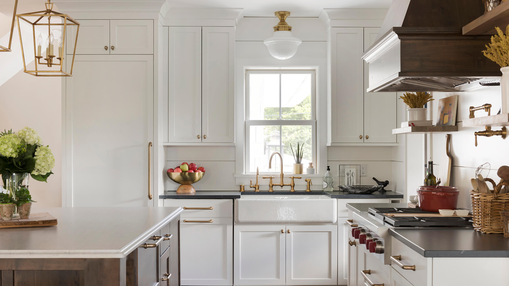 A modern farmhouse kitchen with a hidden appliance panel on the fridge and dishwasher to create a more cohesive design.