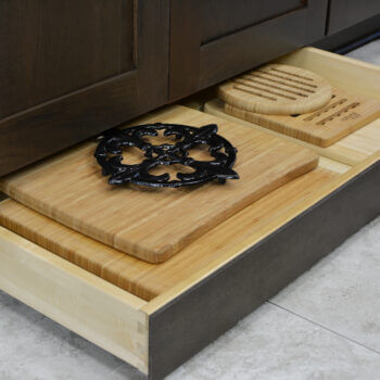 Miscellaneous items can find a home in a Dura Supreme Toe-Kick Drawer hidden at the foot of your cabinets. This convenient solution adds additional storage to your home. It’s great for storing your cutting boards, trivets, rolling pins, and much more!
