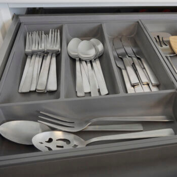 Modern kitchen cabinet drawer storage. Stainless Steel Cutlery Divider Tray from Dura Supreme Cabinetry.