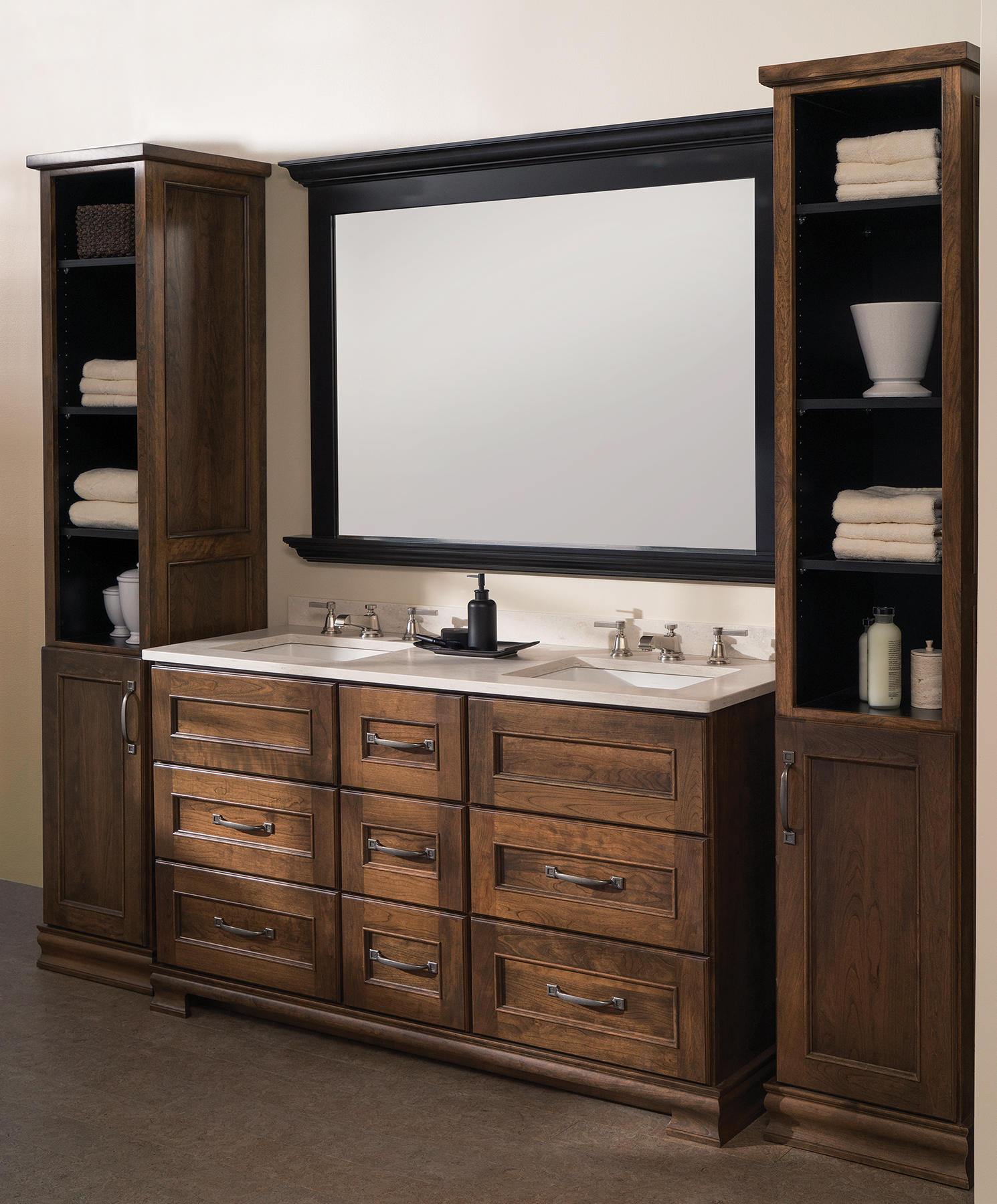 A masculine bathroom vanity with furniture-like details and two free standing linen cabinets.