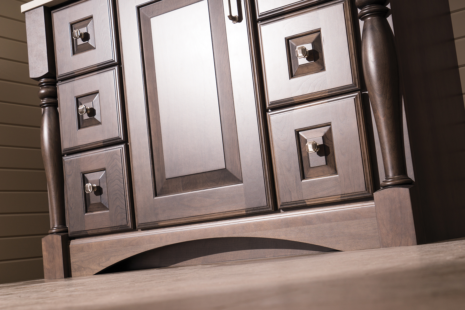 A close up of a traditional styled vanity with an elegant decorative toe kick.