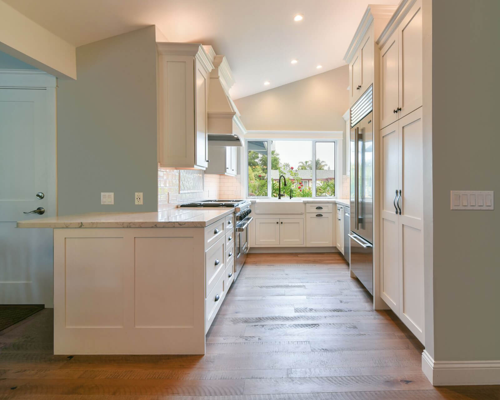 A peninsula kitchen layout that increased the size of the floor plan by adding a peninsula to extend the space.