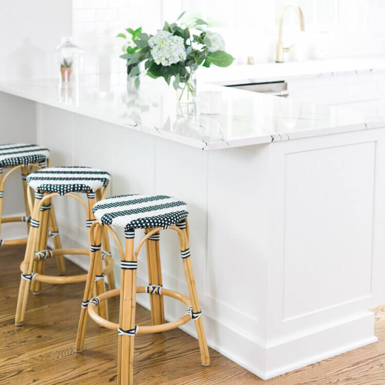 What is a kitchen peninsula and how to design one? This all-white kitchen design features peninsula cabinets with bar stool seating for 3.