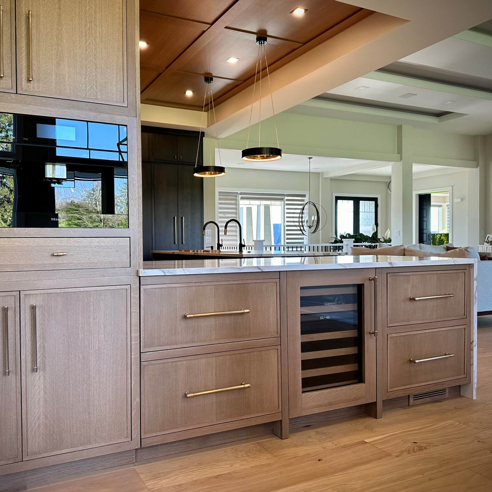 The dining room is defined by a row of peninsula cabinets featuring lots of storage for beverage center.