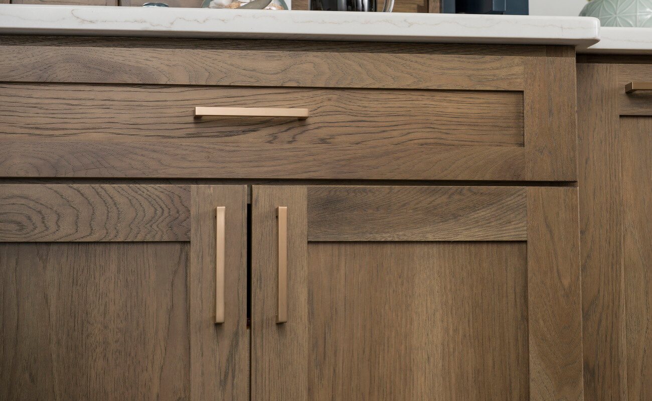 Learn about kitchen design styles and cabinetry selection decisions. This hickory kitchen cabinet has a transitional style look with shaker cabinet doors that have a flat center panel and full overlay construction.