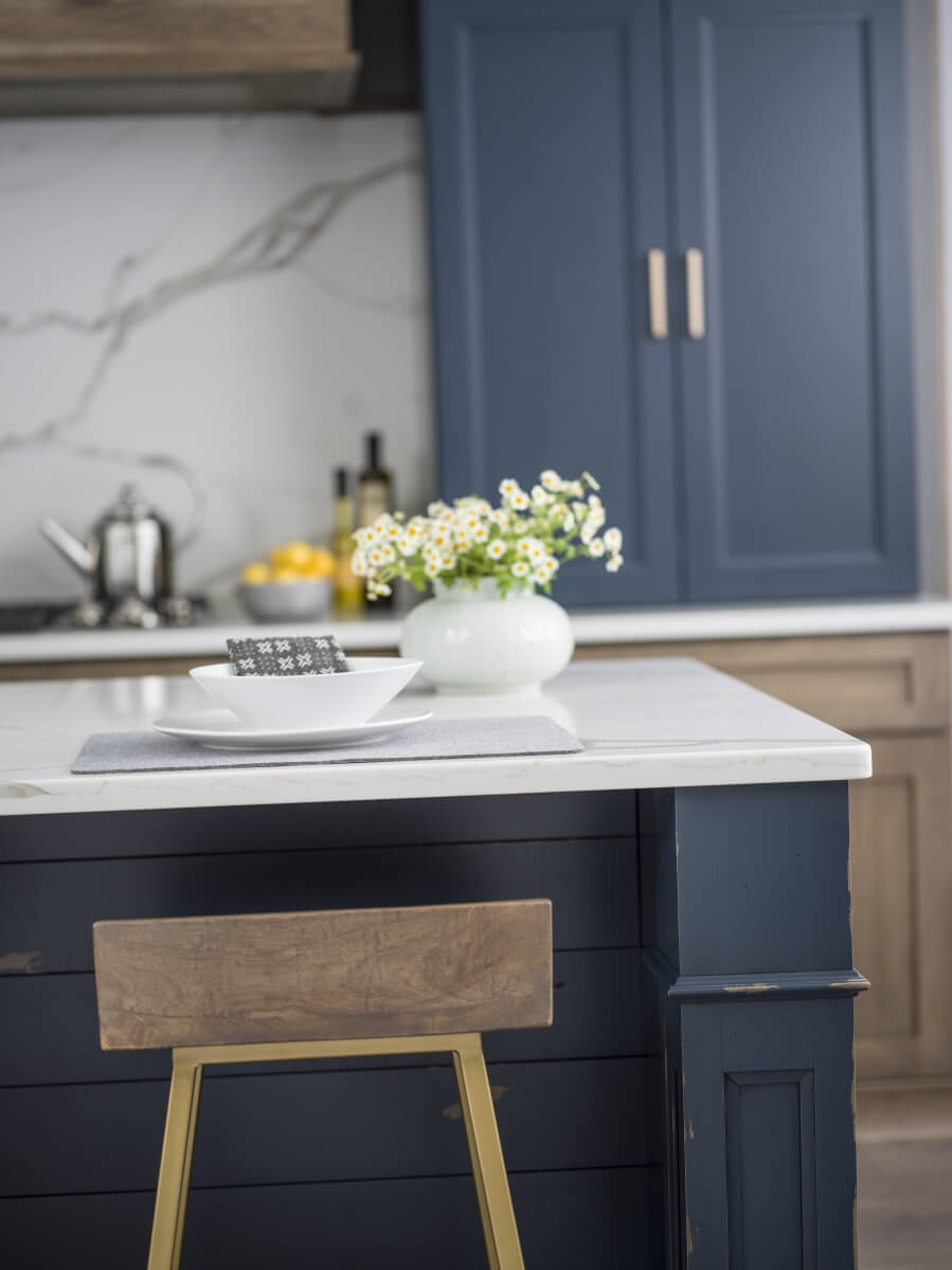 Navy blue and gray brown stained kitchen cabinets in a modern farmhouse styled kitchen remodel.