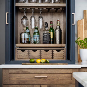 Dura Supreme Cabinetry Beverage Center Larder shown used for home bar storage.