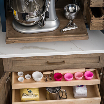 The 5 fundamental kitchen layouts. You can improve a kitchen design with a new kitchen layout and functional kitchen storage like this cabinet with roll-out shelves and small drawers for organizing baking supplies.