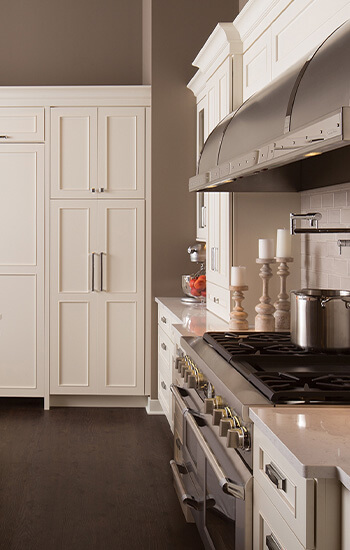 Which Kitchen Layout is best for me? This L-shaped kitchen design has transitional style with white painted cabinets and tan painted walls.