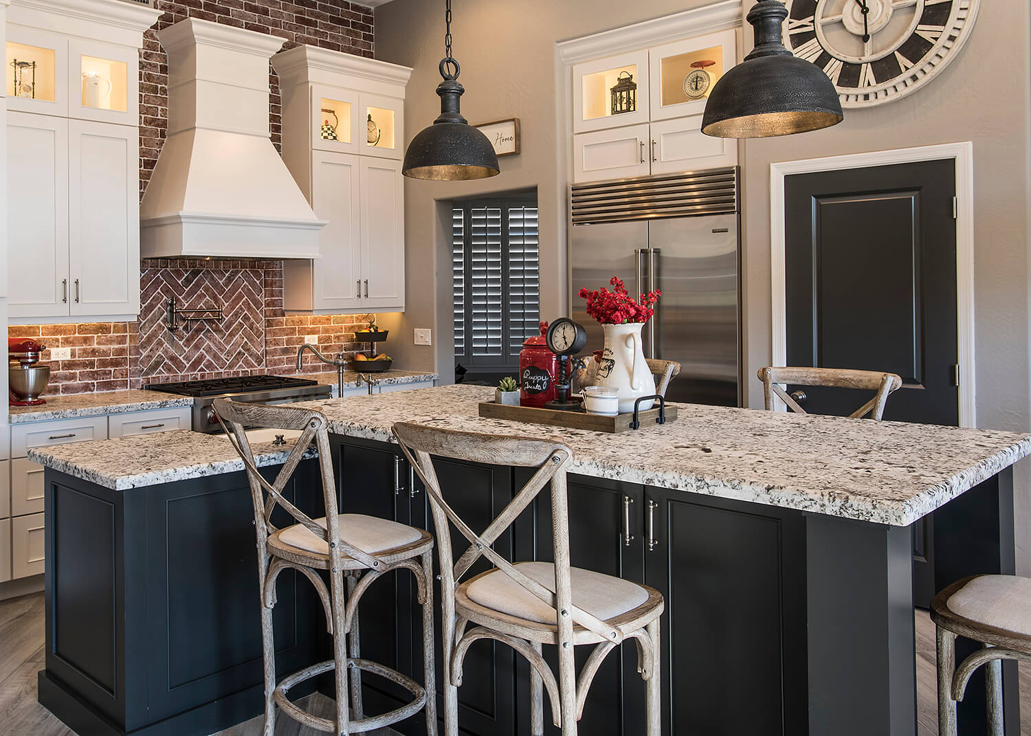 A t-shaped kitchen island with a sink at standard counter height and seating for five at bar height.