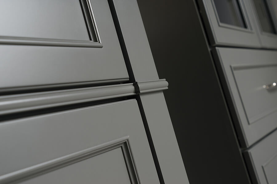 Dark gray and trendy cabinets shown close up of the door style and modling details.