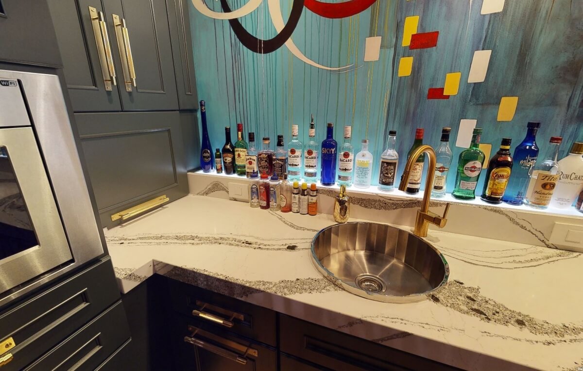 A decorative wet bar sink with a mirror look is a like a jewel in this wet bar remodel design.