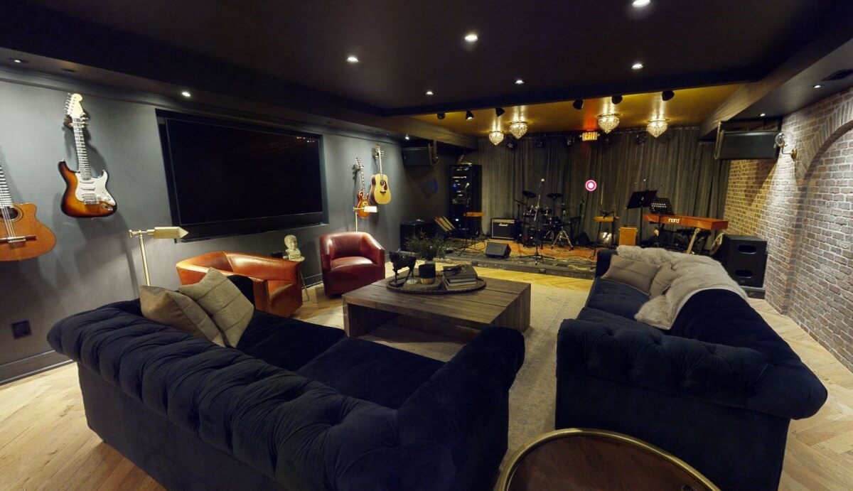 A basement remodel with a stage for musical performances.