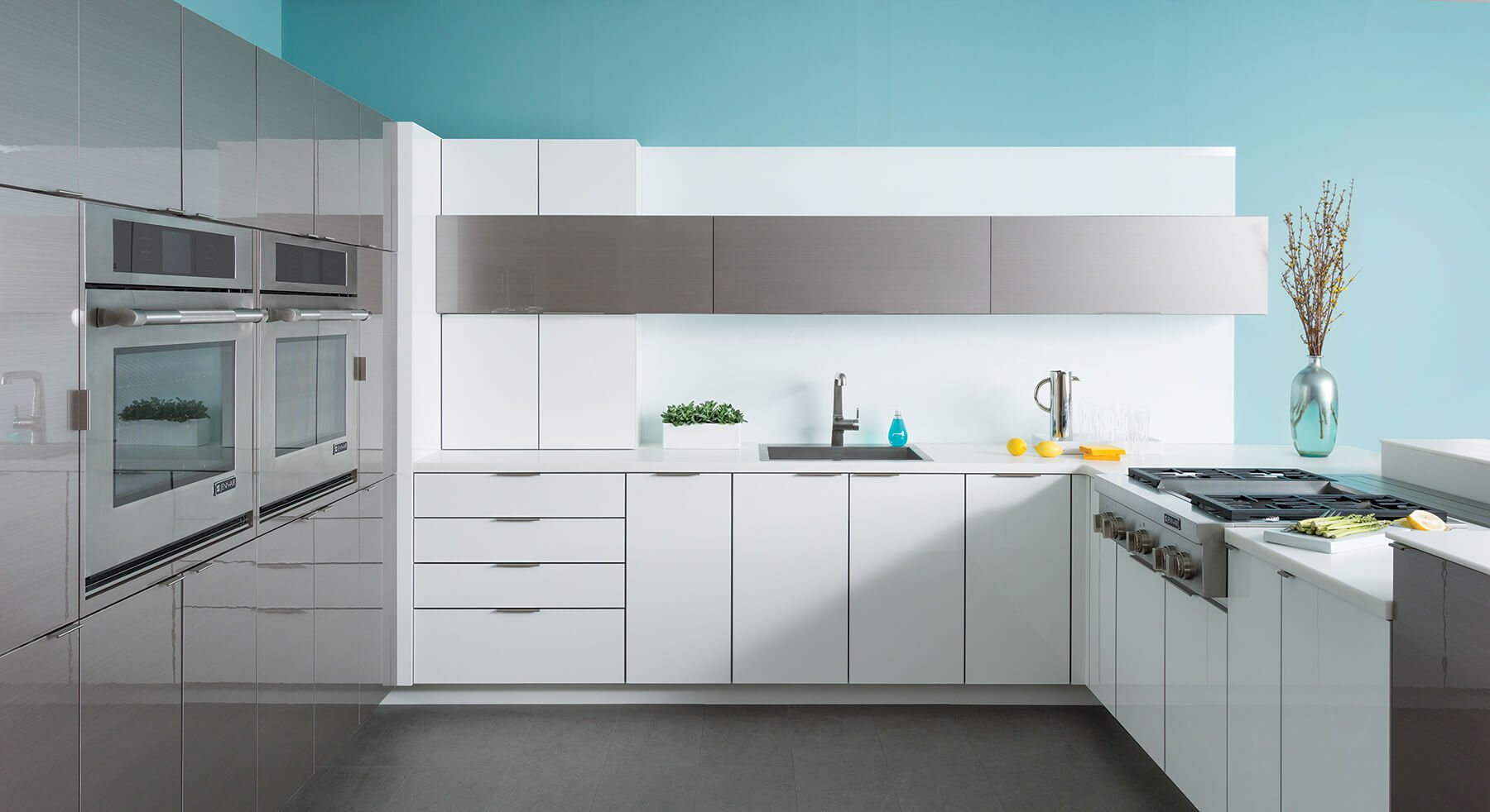 An ultra modern white and grey kitchen design with glossy contemporary cabinetry.