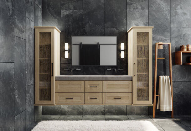 A floating vanity in a contemporary bathroom with a shallow shaker door style in a light raw quarter-sawn white oak color. Two tall floating linen cabinets flank each side of the vanity.