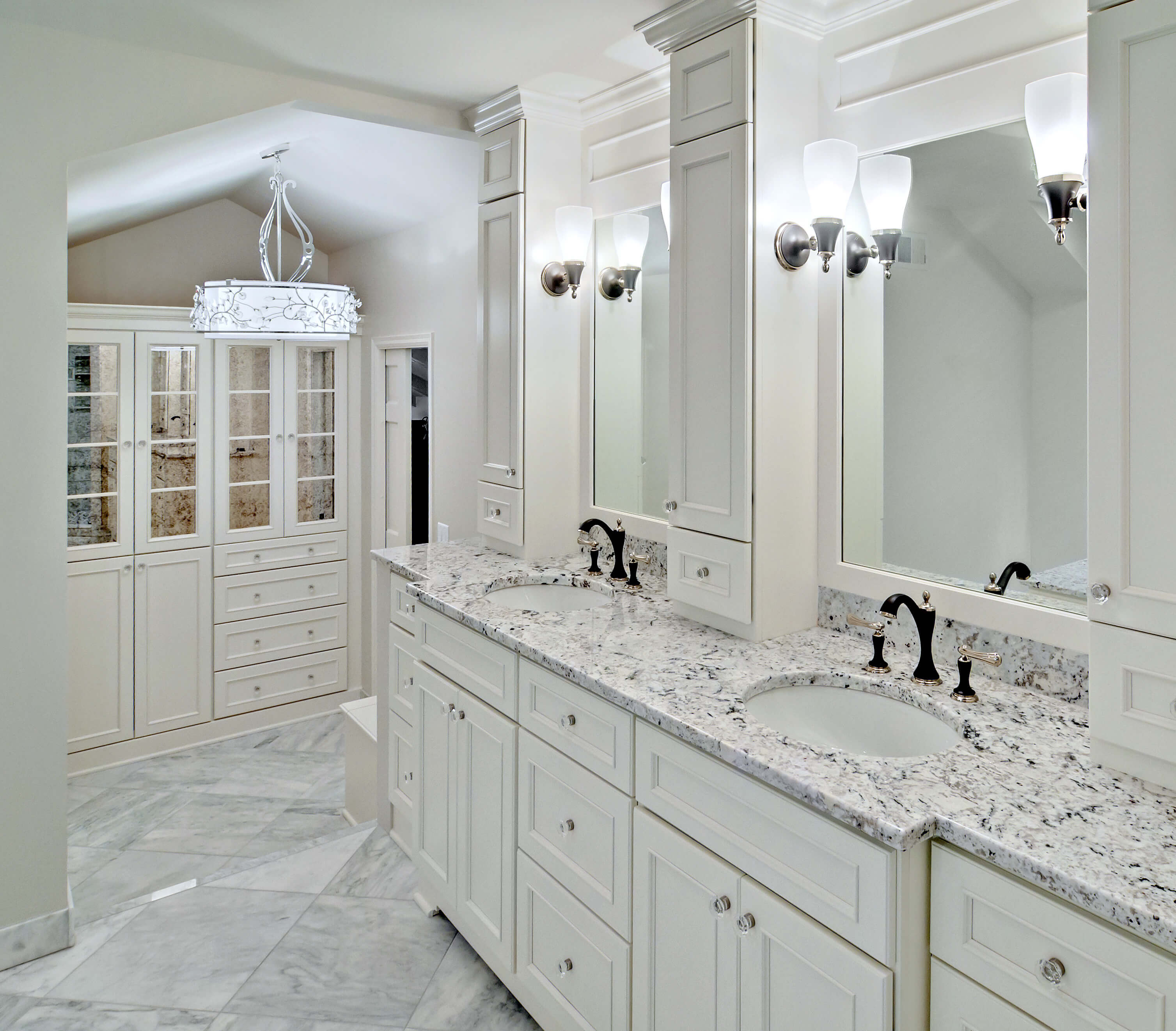 A master bathroom with an all white color palette with mirror mullion cabinet doors.