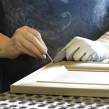 An image of a cabinetry door expert working hard to craft the details of a cabinet door at the manufacturing facility in Howard Lake, Minnesota.