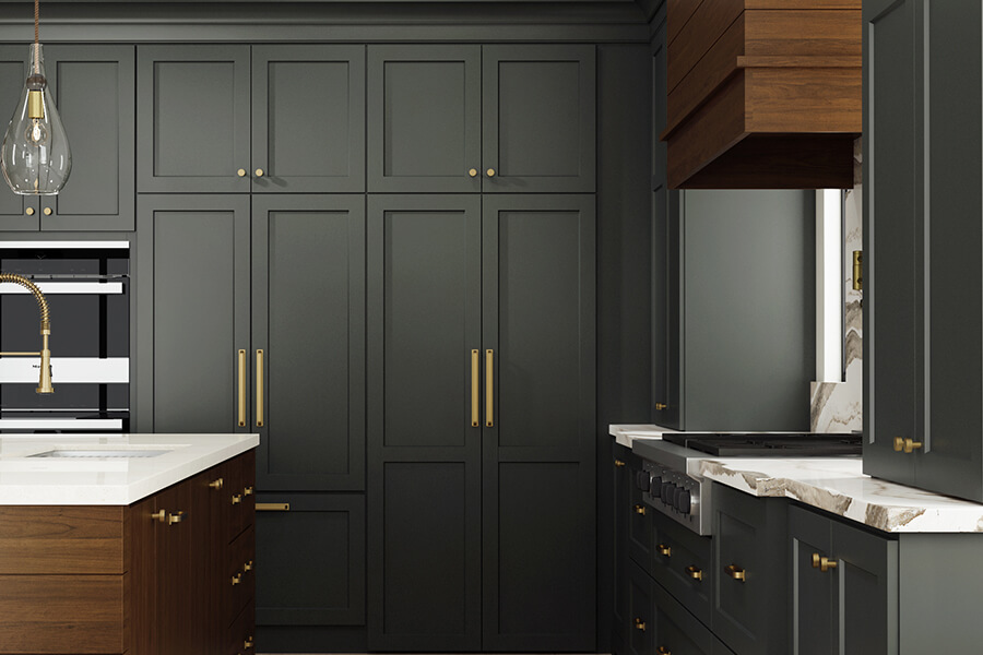 A dark green kitchen with green painted cabinets and warm wood accents.