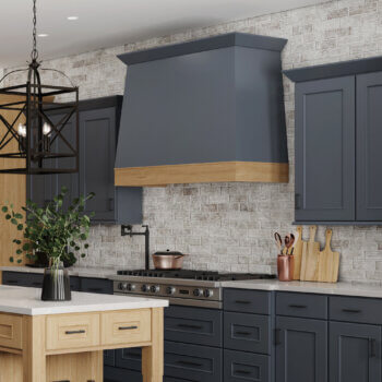 A two-toned modern wood hood with a dark navy blue canopy and a light stained cherry frieze.