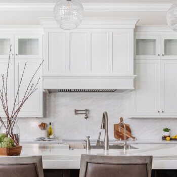 A built-in integrated wood hood with panels that match the cabinet door style.