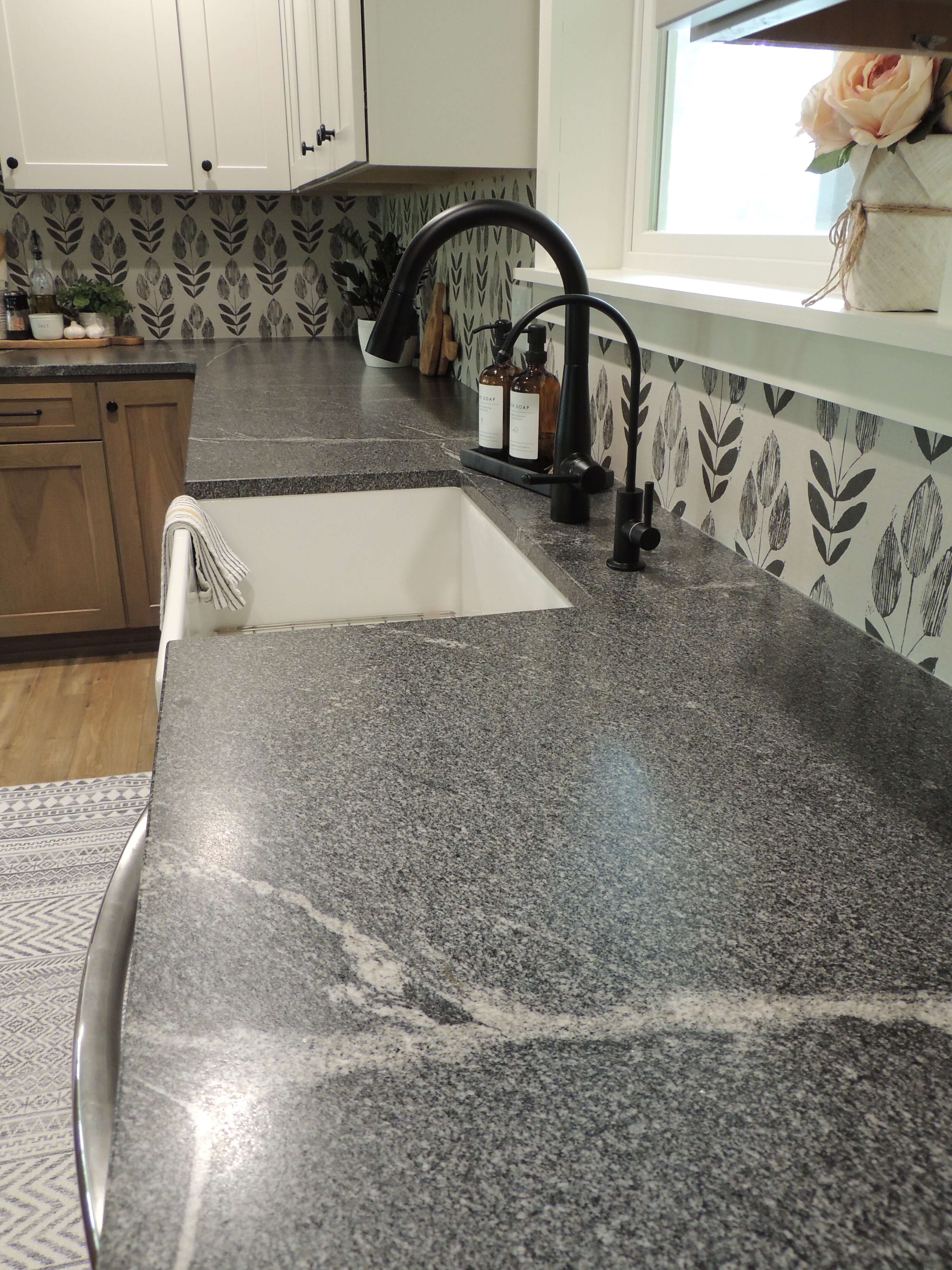 A close up of the Honed Granite countertops near the kitchen sink.
