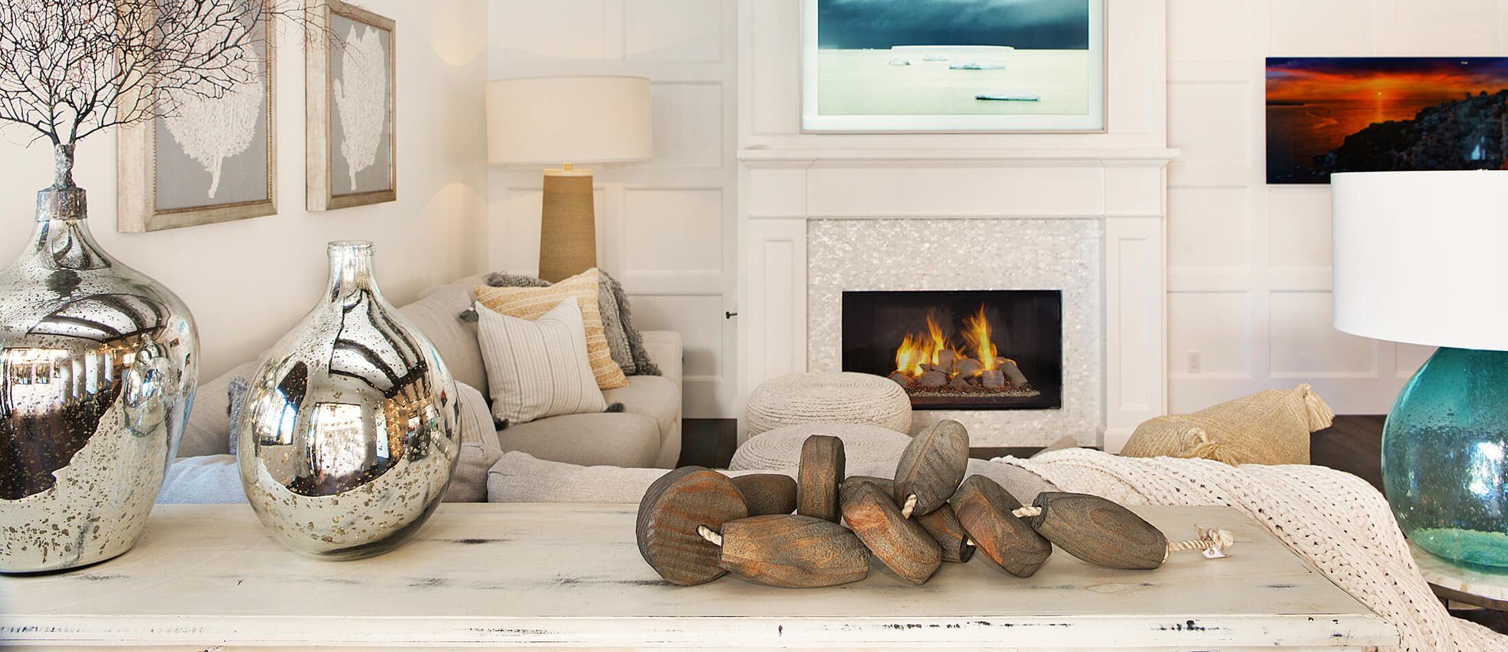 A Coastal style living room interior design with a custom fireplace from Dura Supreme Cabinetry.