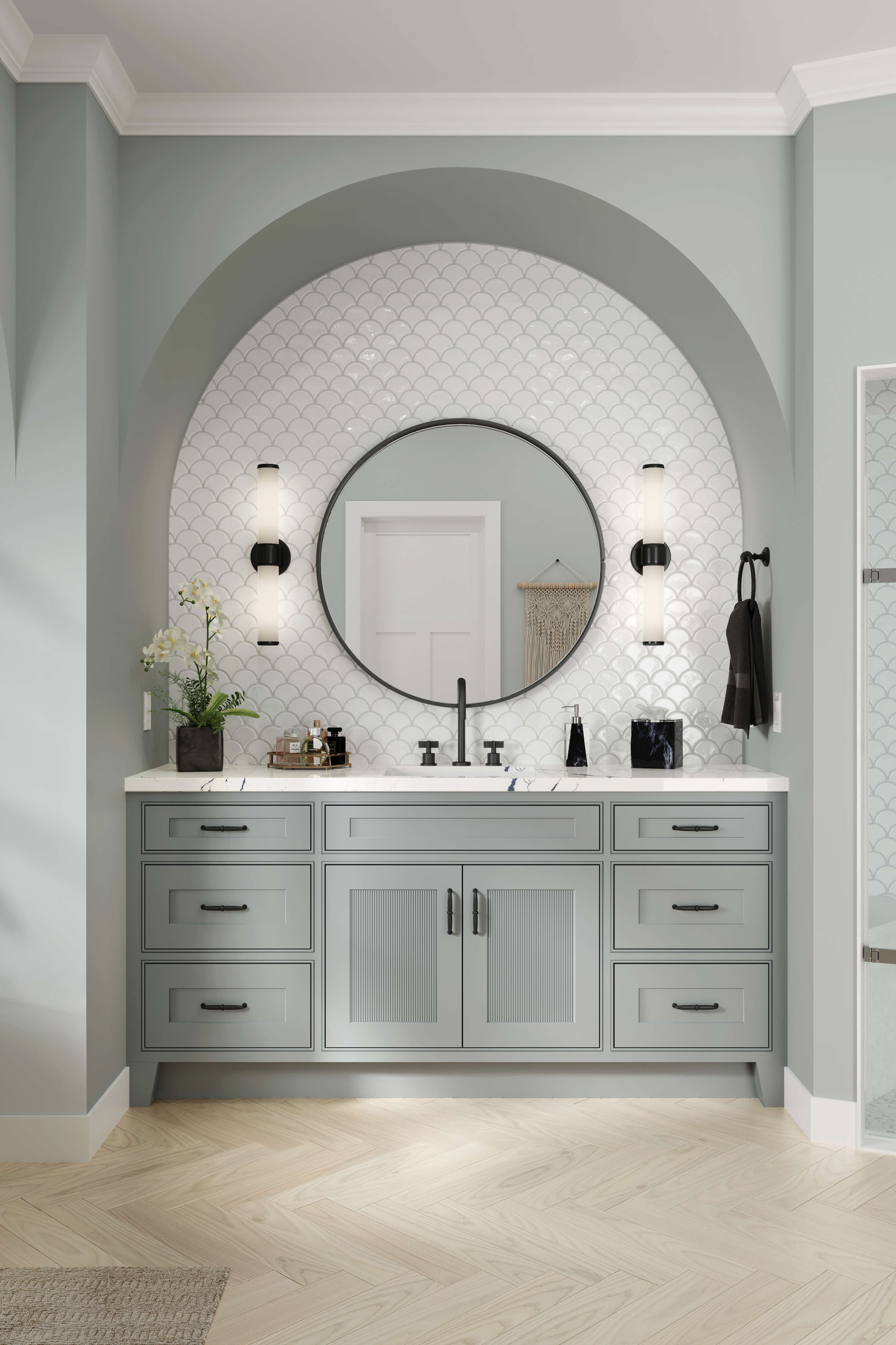 A beautiful bathroom with an arched wall and sunk-in vanity with reeded panel cabinet doors.