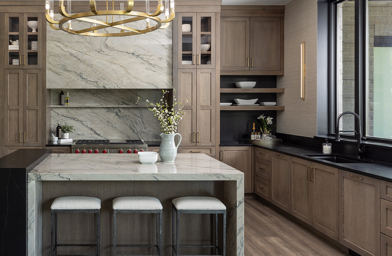 An on-trend kitchen design with true-brown stained cabinets with black accents using Dura Supreme's semi-custom to custom cabinet products.