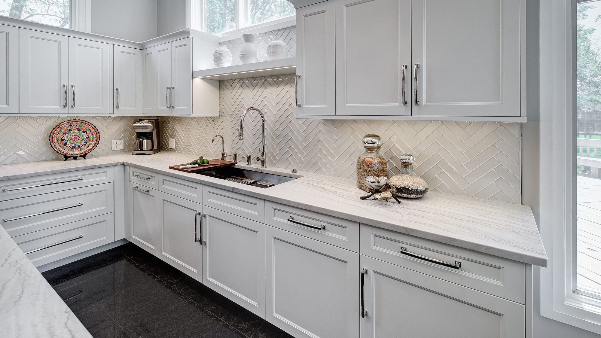 An all-white kitchen design with a sleek flat panel door style from Dura Supreme with sophisticated profile details on the stiles and rails.