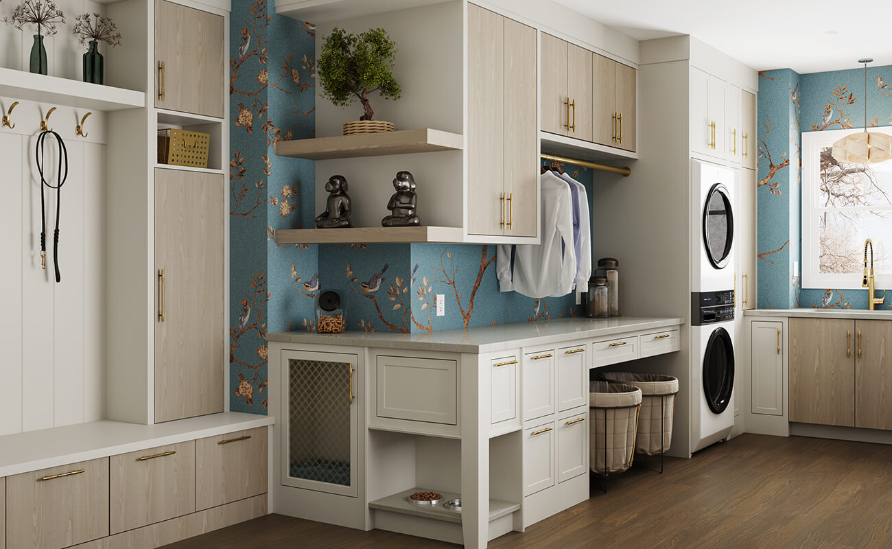 A beautiful laundry room and mudroom designed with the pets in mind. A dog dish cabinet and a kennel cabinet are integrated into the space.