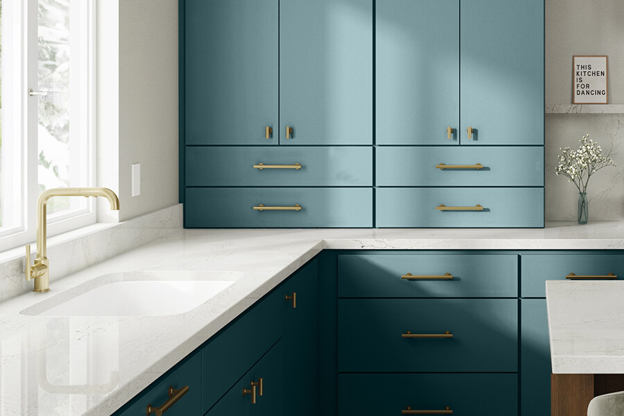 A contemporary teal blue kitchen with matte cabinets featuring a slab door style and modern minimalism.