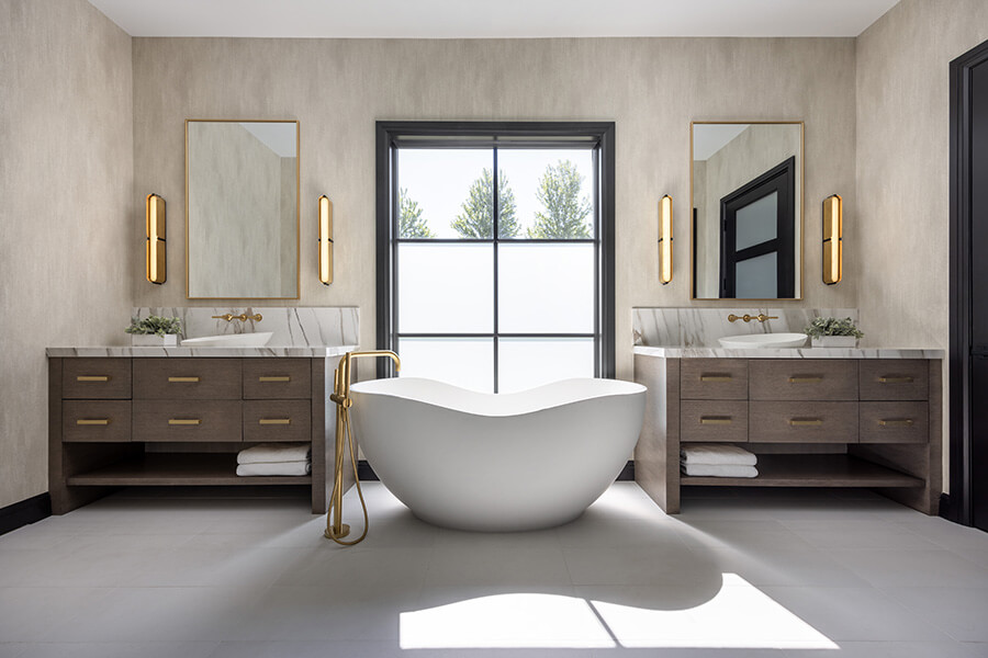 A sleek, modern master bathroom with double furniture style vanities with minimalistic details and design.