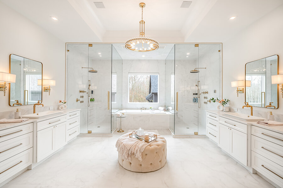 A classy all white master bathroom design with transitional styled shaker cabinets.