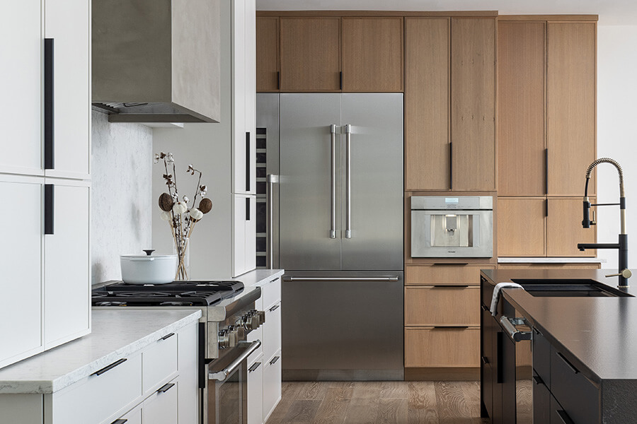 A contemporary kitchen with modern skinny shaker cabinets in three-toned cabinet colors.