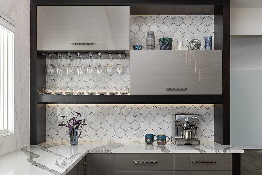 An ultra modern and glossy kitchen design featuring Dura Supreme cabinets and floating shelves.
