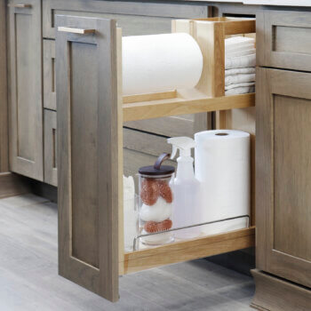 This base cabinet pull-out has built-in paper towel roll storage that fits jumbo sized rolls. with a shelf and compartment for additional storage for cleaning supplies.
