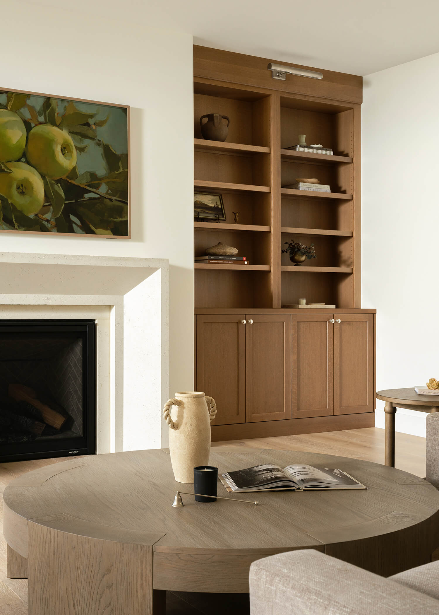 The cabinet and bookcase built-ins around the fireplace in this living room design feature a light to medium stained finish on Quartersawn Oak wood.