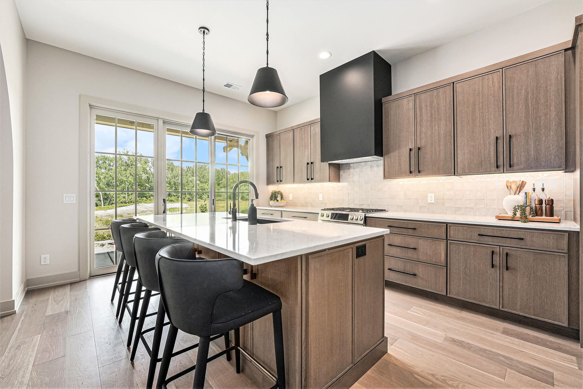 A beautiful modern farmhouse kitchen design with true-brown stained finish on quartersawn white oak cabinets.